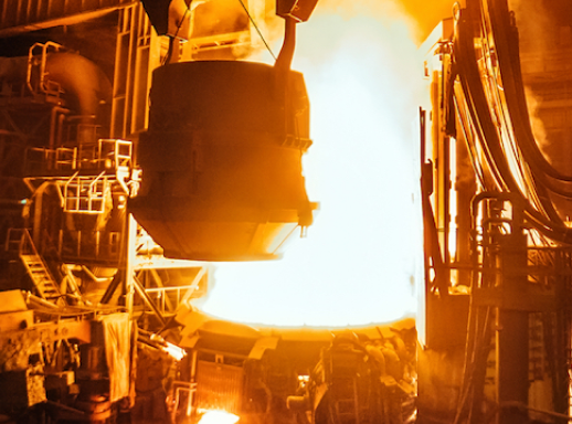 Scrap ready to be poured into furnace inside steel mill.