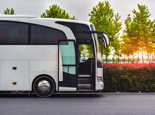 travel company bus greets tourists at the airport to take to the hotel